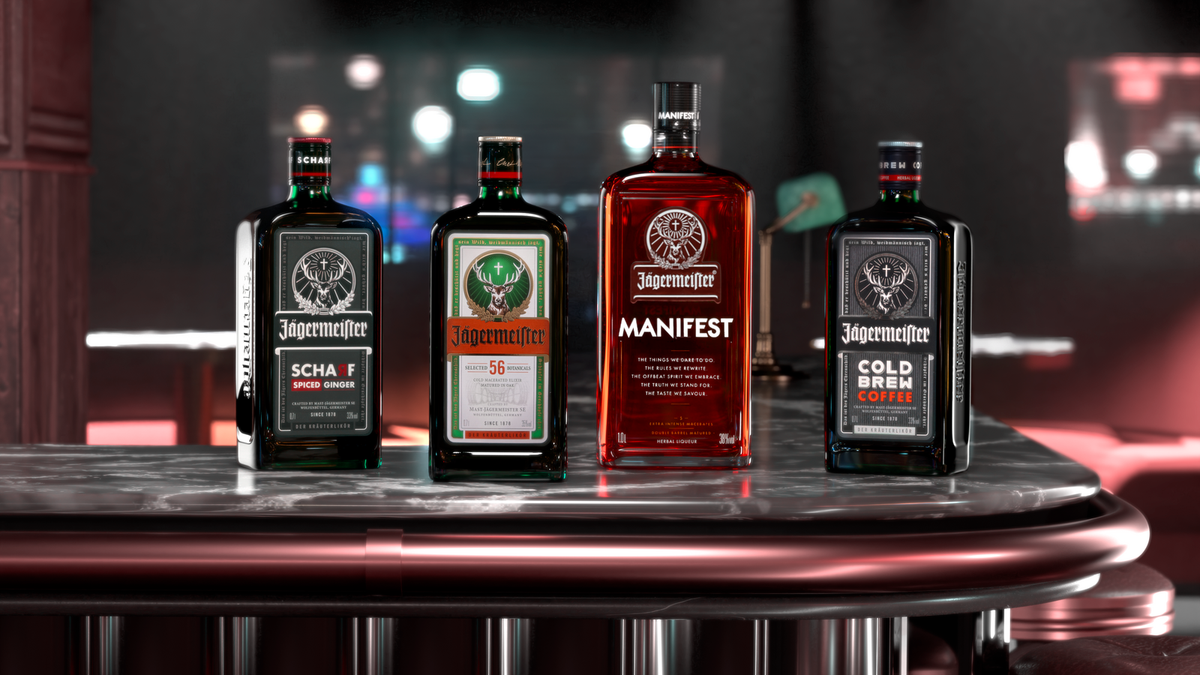 Four Jägermeister liquor bottles displayed side by side on a polished bar counter in a dimly lit bar setting. The bottles include Jägermeister Scharf, Jägermeister Original, Jägermeister Manifest, and Jägermeister Cold Brew Coffee.