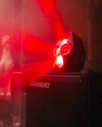 Soundboks speaker with red shining Lightboks on top in a dark setting