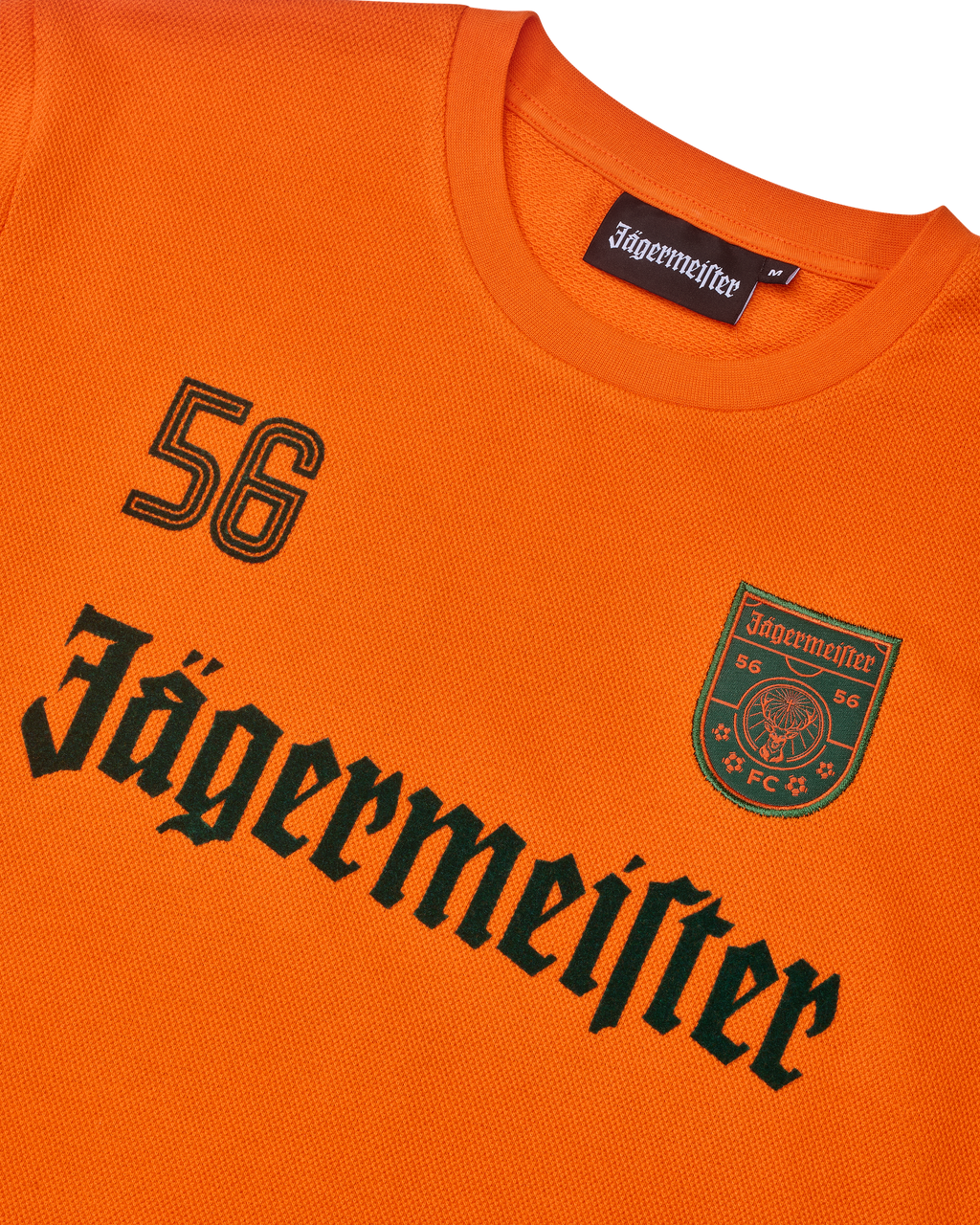 Bluză cu mânecă lungă portocalie Jägermeister, cu logoul Jägermeister negru și un „56”.