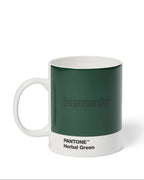 Jägermeister mug with Pantone Herbal Green color swatch on a white background
