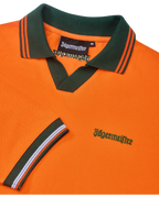 Orange Jägermeister polo shirt with green collar and orange trim featuring green Jägermeister branding.