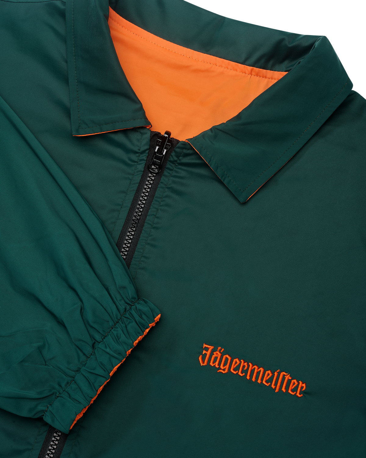 Close-up of the reversible Jägermeister jacket with a zipper showing the green side