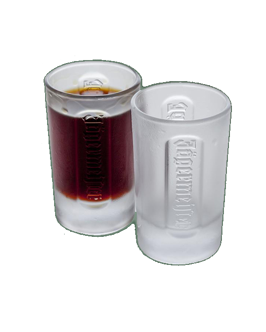 Two white Jägermeister shot glasses with a dark liquid inside
